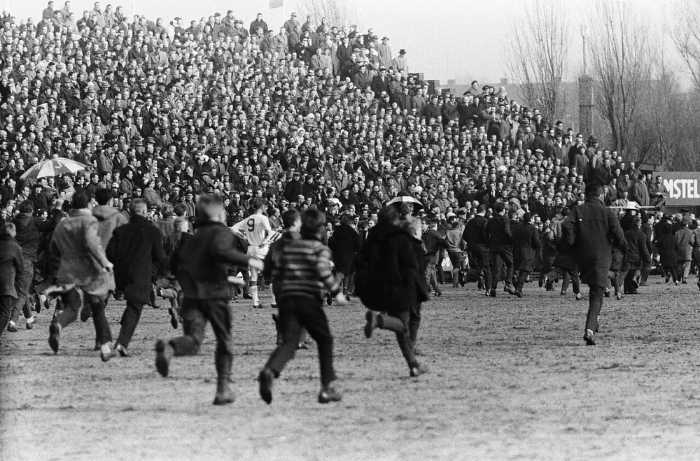 Ajax tegen Feijenoord 1-3. Supporters op het veld. Foto: Harry Pot / Anefo, Nationaal Archief (CC0).